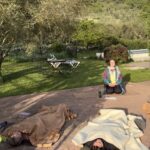 Miriam guiding participants through outdoor Savasana